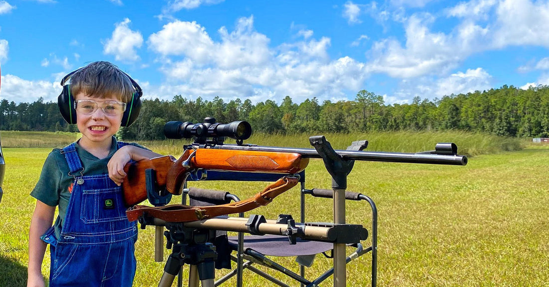 A child safely beside a gun.