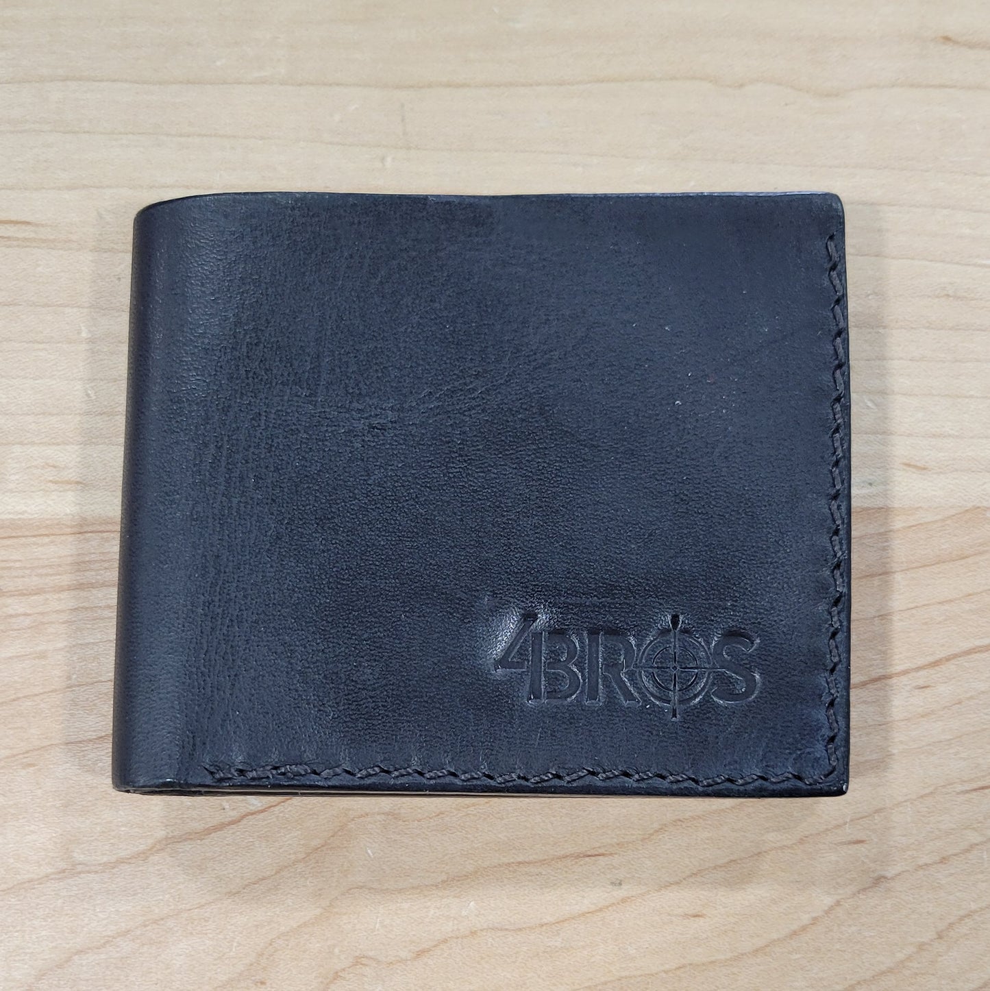 Our 4Bros Wallet is 100% hand-made in Cass County, Indiana. The single-fold design has four pockets on each side, three sized for credit cards, and one hidden pocket behind the card pockets. We use 5-6 ounce leather for the exterior and goat skin for the interior to keep the weight and thickness to a minimum.