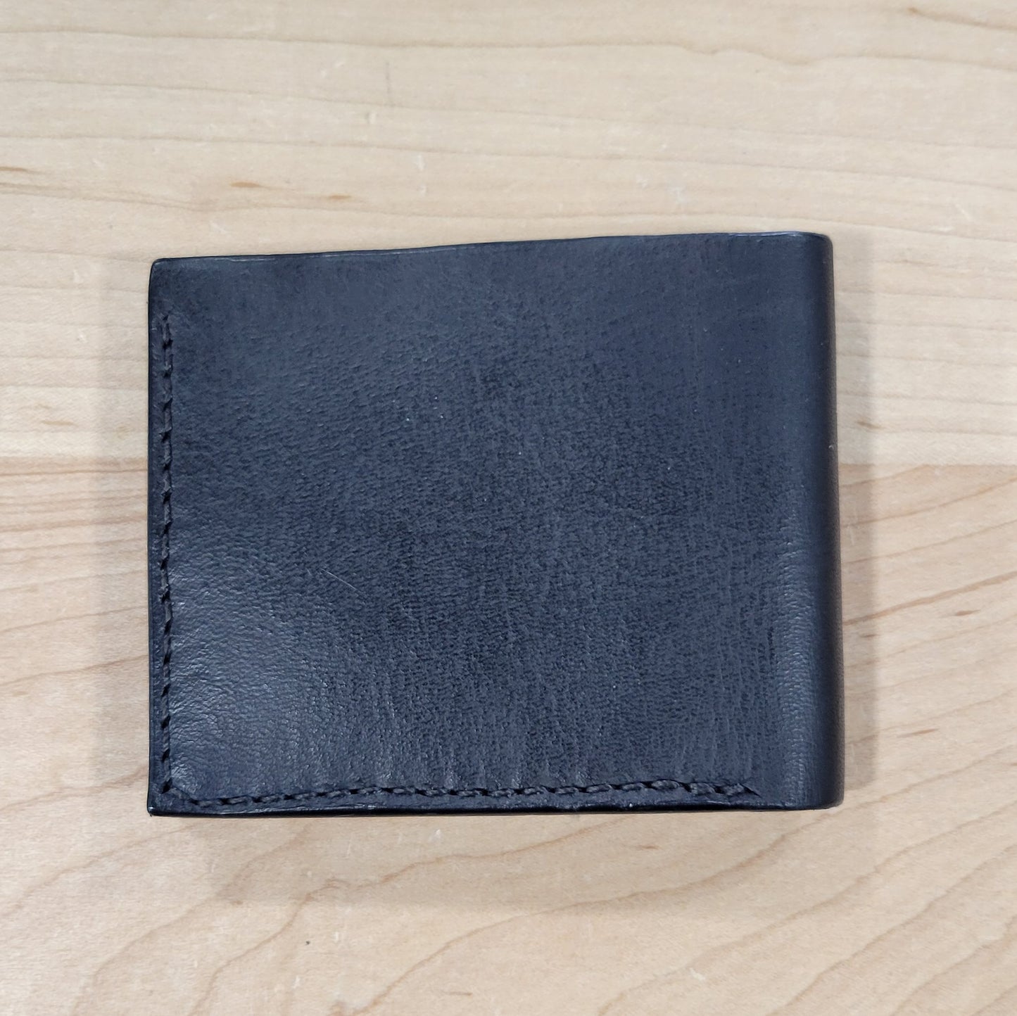 Our 4Bros Wallet is 100% hand-made in Cass County, Indiana. The single-fold design has four pockets on each side, three sized for credit cards, and one hidden pocket behind the card pockets. We use 5-6 ounce leather for the exterior and goat skin for the interior to keep the weight and thickness to a minimum.
