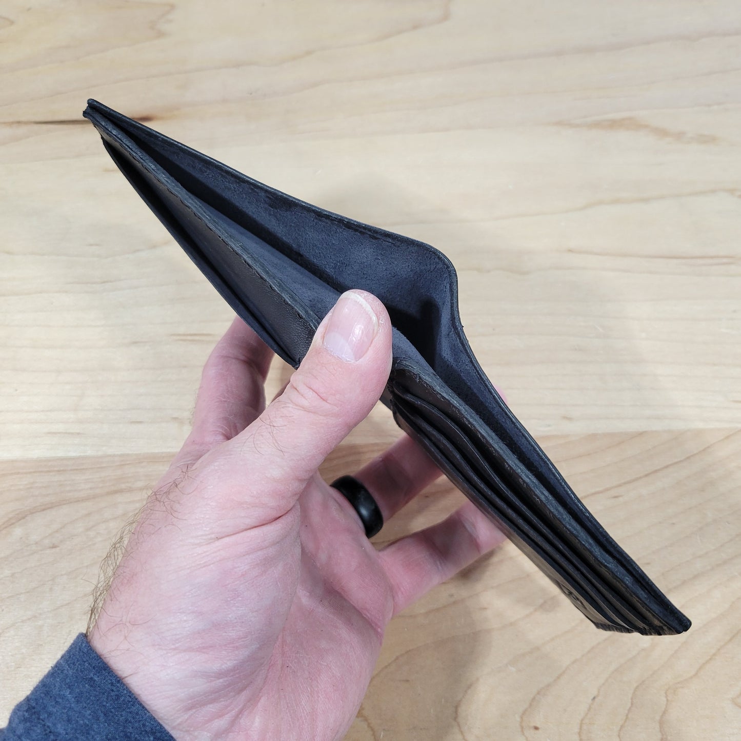 Our 4Bros Wallet is 100% hand-made in Cass County, Indiana. The single-fold design has four pockets on each side, three sized for credit cards, and one hidden pocket behind the card pockets. We use 5-6 ounce leather for the exterior and goat skin for the interior to keep the weight and thickness to a minimum.