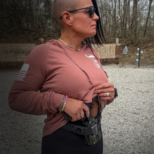 A woman wearing a holster.
