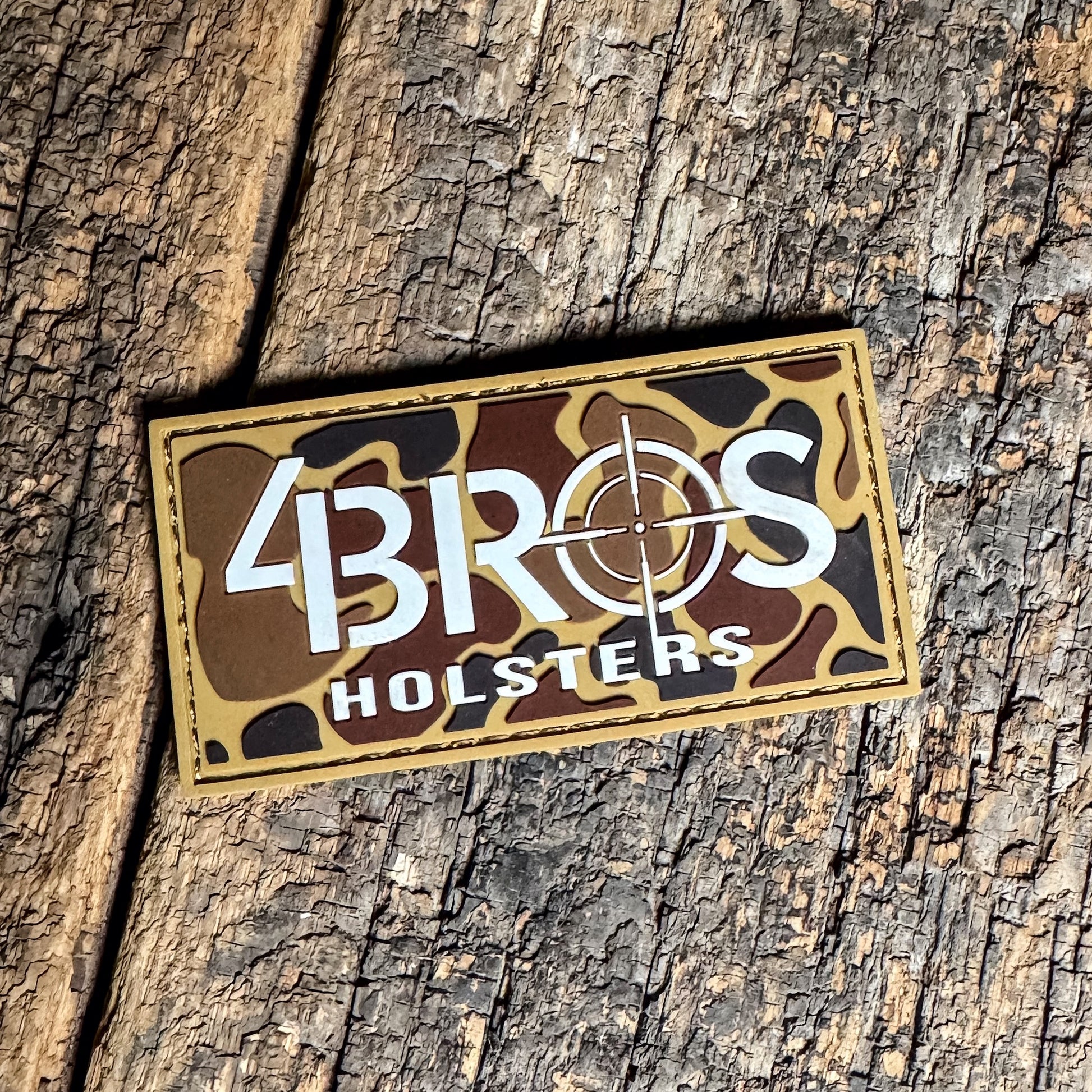 4BROS Holsters Logo Duck Camo PVC Patch measures 1 3/4" x 3 1/2" with a bold white logo on a duck camo background for range bags and gear.