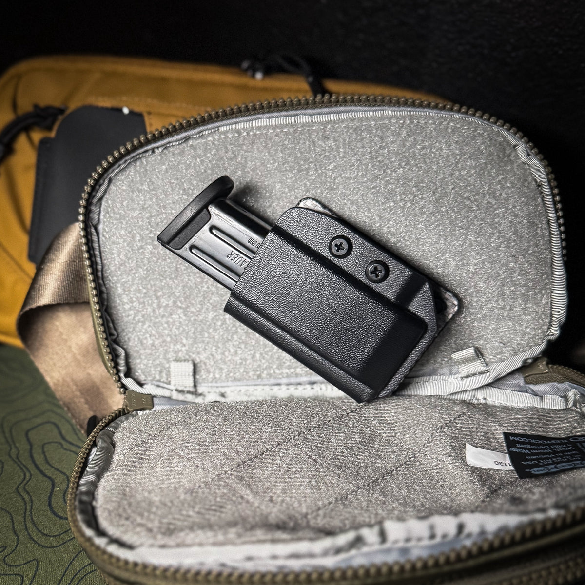 Hook and Loop magazine and accessory mount for backpacks and sling bags. Fits Velcro-compatible panels for secure off-body EDC carry. Made in the USA