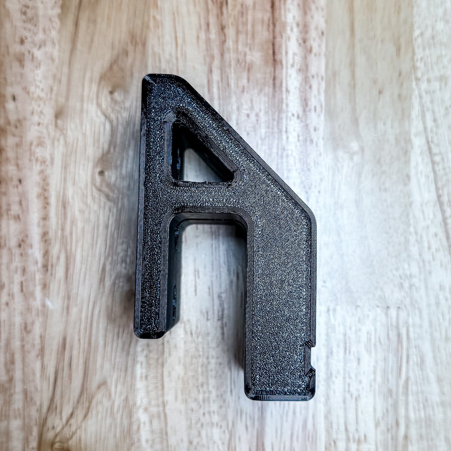 AR-15 rifle wall hanger designed for mil-spec lowers. Secure magwell retention, stud-mounted strength, and durable PETG construction. Made in USA