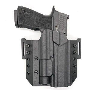 Outside Waistband Pancake Style Kydex holster designed to fit the Sig Sauer 10MM P320-XTEN and Streamlight TLR-1 or TLR-1 HL. Full sweat guard, adjustable retention, open muzzle cleared for a red dot sight. Proudly made in the USA for veterans & law enforcement. 10 MM P320 XTEN, P320 X Ten, or P 320 XTEN.