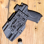 For the best Outside Waistband OWB Kydex Taco Style Holster designed to fit the Smith and Wesson M&P 10MM M2.0 4" or 4.6" pistol with thumb safety and Surefire X300U-A, X300U-B, X300T-A or X300T-B, shop four brothers holsters. Full sweat guard, adjustable retention, profiled for a red dot sight. Made in the USA.