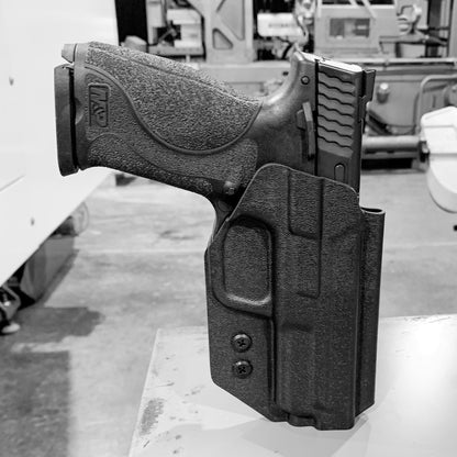 For the 2023 Best Outside Waistband OWB Kydex Holster designed to fit the Smith and Wesson M&P 4.25”, 4", and 3.6 Full Size and Compact pistol, shop Four Brothers Holsters. Holster fits M1.0 and M2. 0 generations.  Full sweat guard, adjustable retention, profiled for a red dot sight. Made in the USA. M1 M2