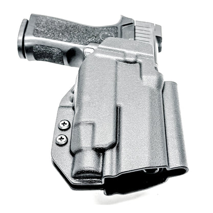 Black Outside Waistband OWB Holster for the Sig Sauer P320 Compact/Carry pistol and a Streamlight TLR-7 X or HL-X & Align Tactical Thumb Rest shown with a 4BROS 1.5" Belt Slide.
