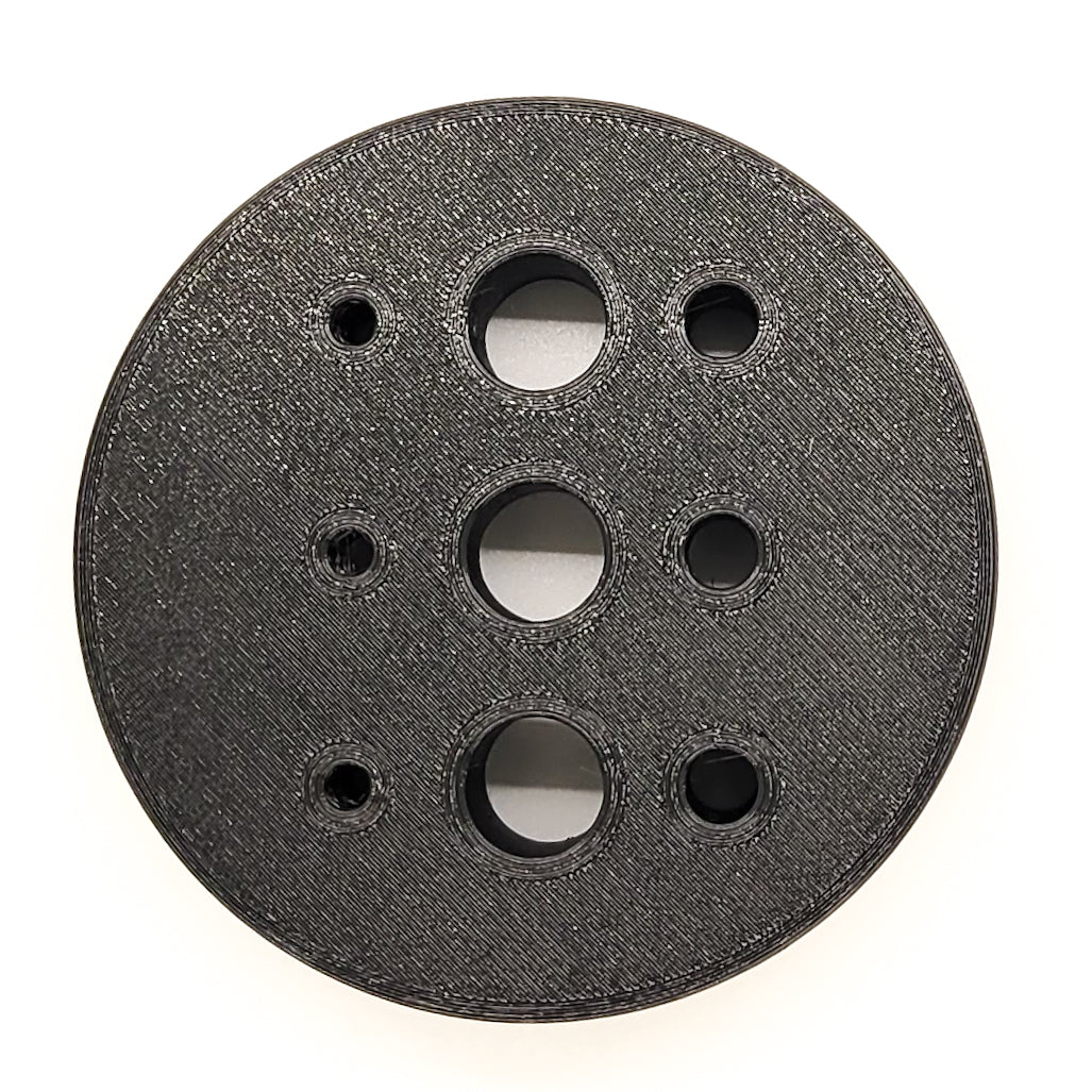 Our 3D-printed Armorer & Gunsmith Universal Bench Block makes the removal of pins from firearms & devices simple, easy, and quick. With one flat section, two grooves, and three hole sizes this block will provide a solid surface to hold frames, receivers, and slides while tapping out pins and not marring the finish.