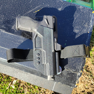 Outside Waistband Duty & Competition Kydex holster designed to fit the TaurusTX 22 Competition Pistol with Blade-Tech Duty Drop and Offset Attachment and a Black 4Bros Thigh Strap. Full sweat guard, adjustable retention, open muzzle, cleared for a red dot sight. Proudly made in the USA. TX 22 TX-22 Taurus