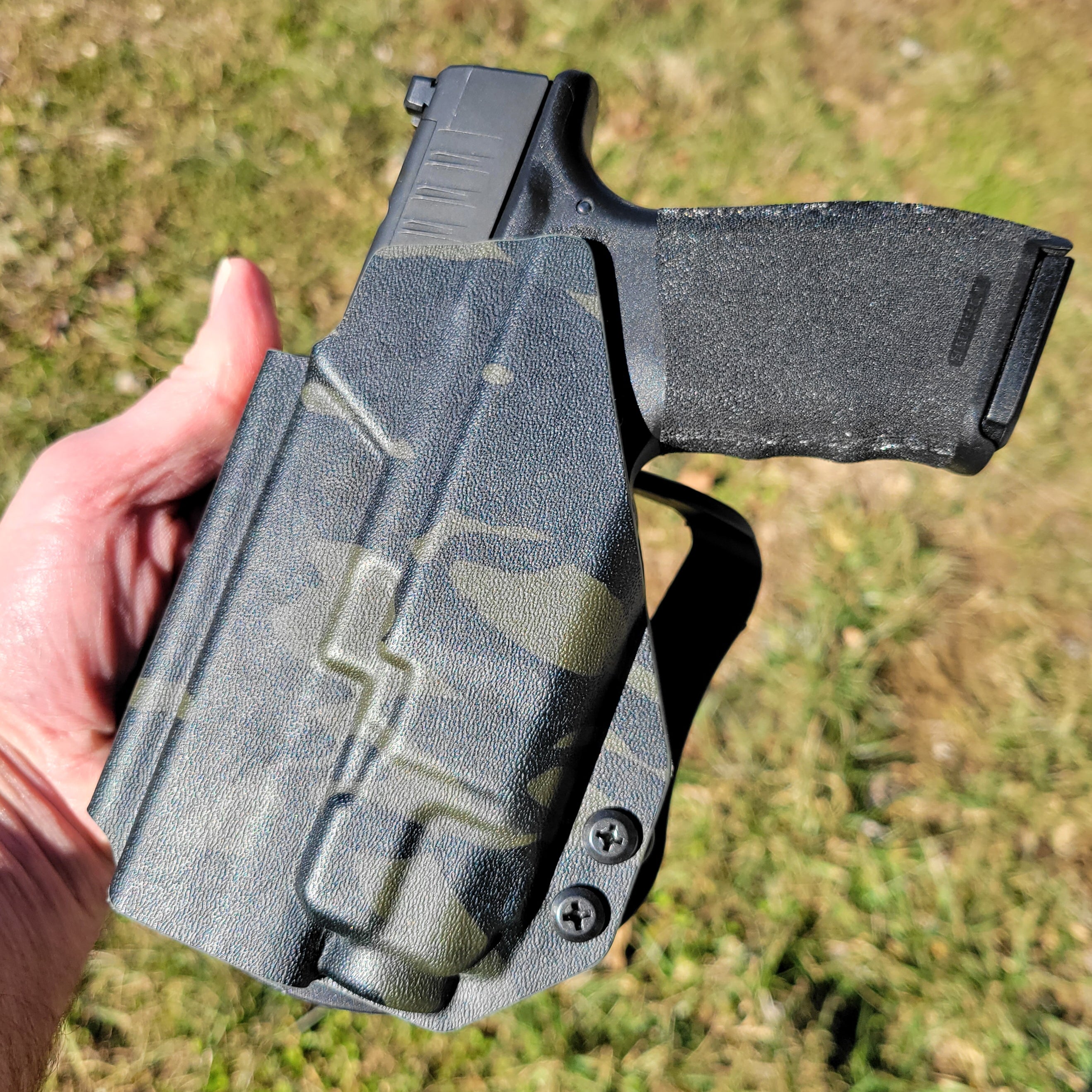 Outside Waistband Holster designed to fit the Springfield Hellcat Pro pistol with the Streamlight TLR-8 & TLR-8A light mounted to the handgun. The holster retention is on the light itself and not the pistol. Full sweat guard, adjustable retention, minimal material, and smooth edges to reduce printing. Made in the USA.