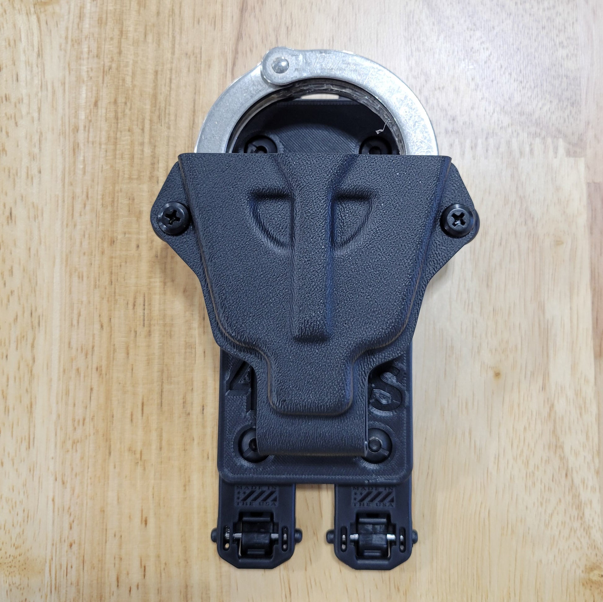 Smith and Wesson Handcuff Holster for the Smith and Wesson chain-style handcuffs from Four Brothers 4Bros Holsters.  This carrier works well on Molle. 