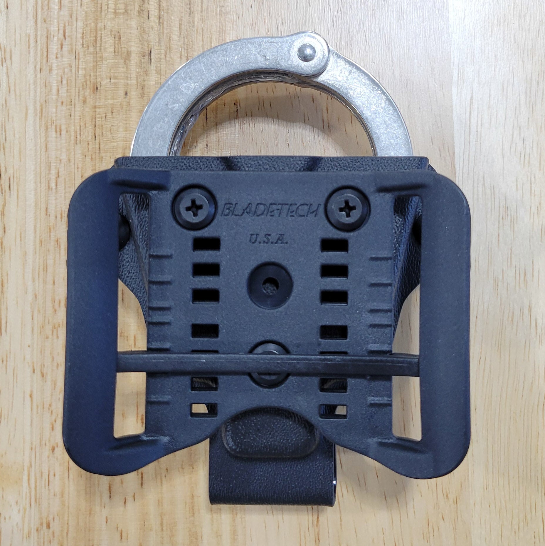 Smith and Wesson Handcuff Holster for the Smith and Wesson chain-style handcuffs from Four Brothers 4Bros Holsters.  This carrier works well on Molle. 