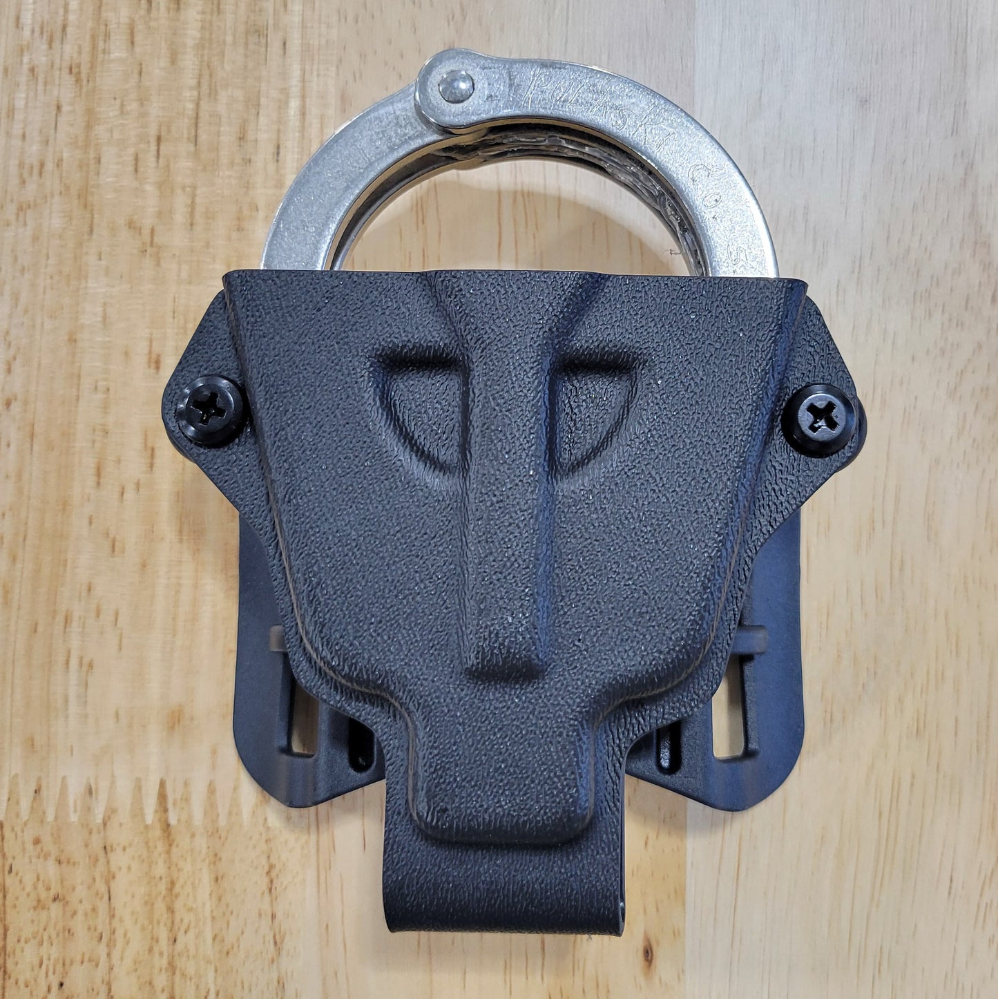 Smith and Wesson Handcuff Holster for the Smith and Wesson chain-style handcuffs from Four Brothers 4Bros Holsters.  This carrier works well on Molle. 