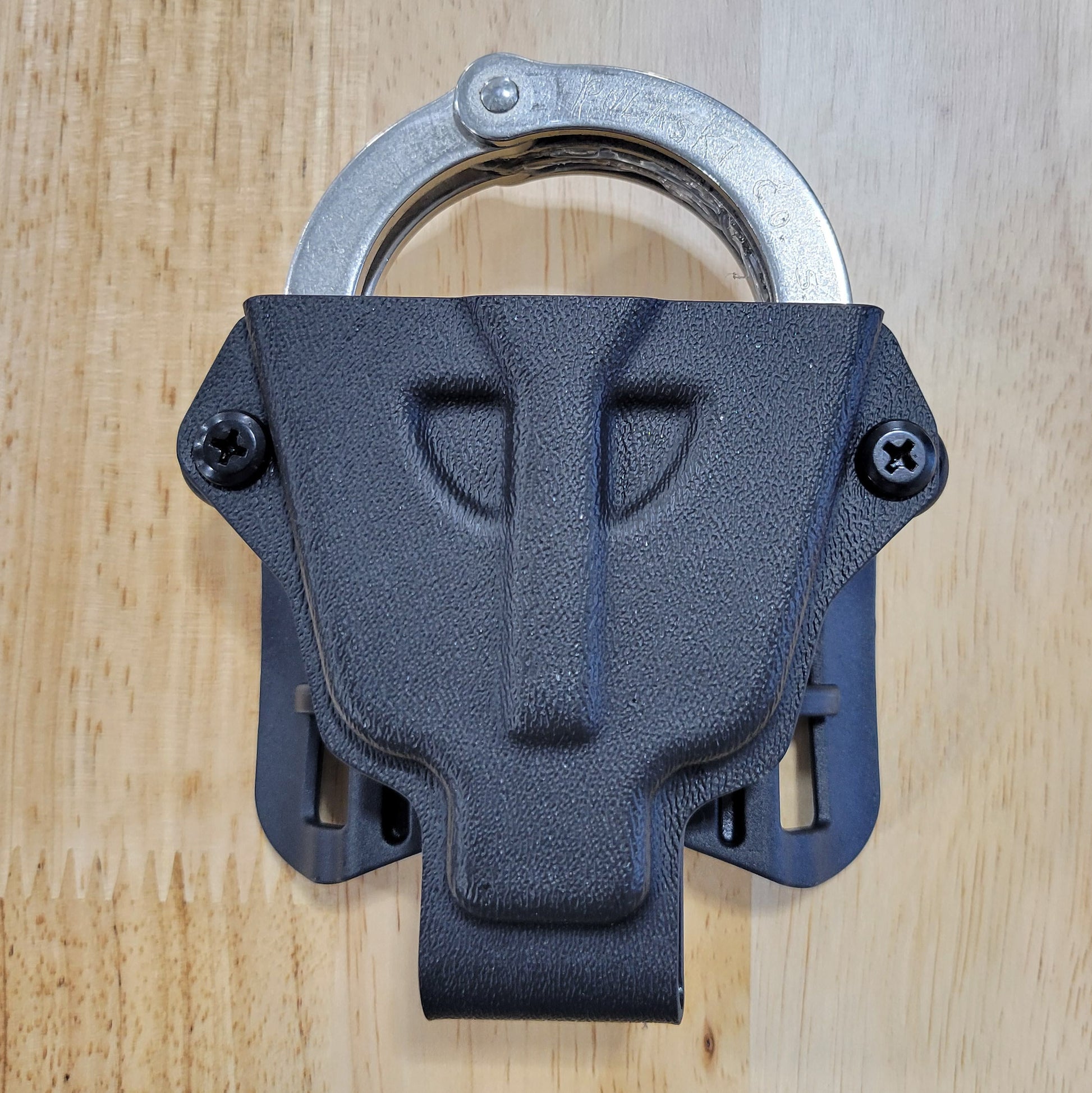 Smith and Wesson Handcuff Holster for the Smith and Wesson chain-style handcuffs from Four Brothers 4Bros Holsters.  This carrier works well on Molle. 