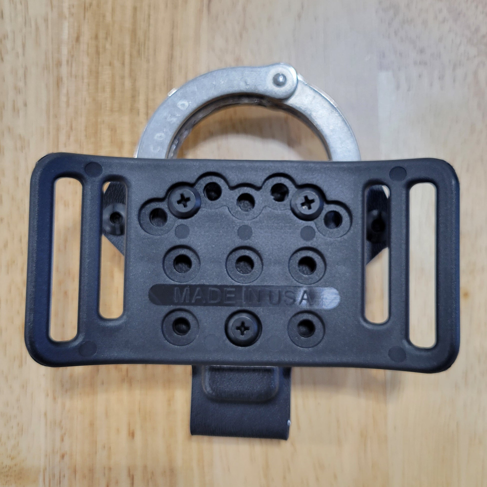 Smith and Wesson Handcuff Holster for the Smith and Wesson chain-style handcuffs from Four Brothers 4Bros Holsters.  This carrier works well on Molle. 