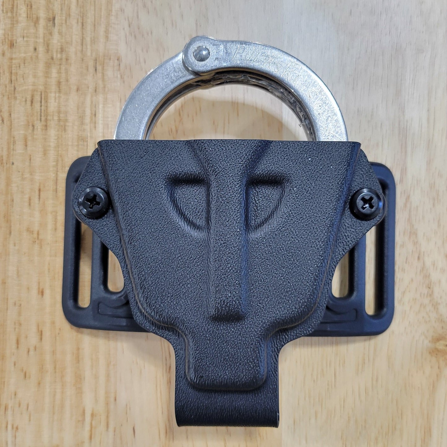 Smith and Wesson Handcuff Holster for the Smith and Wesson chain-style handcuffs from Four Brothers 4Bros Holsters.  This carrier works well on Molle. 