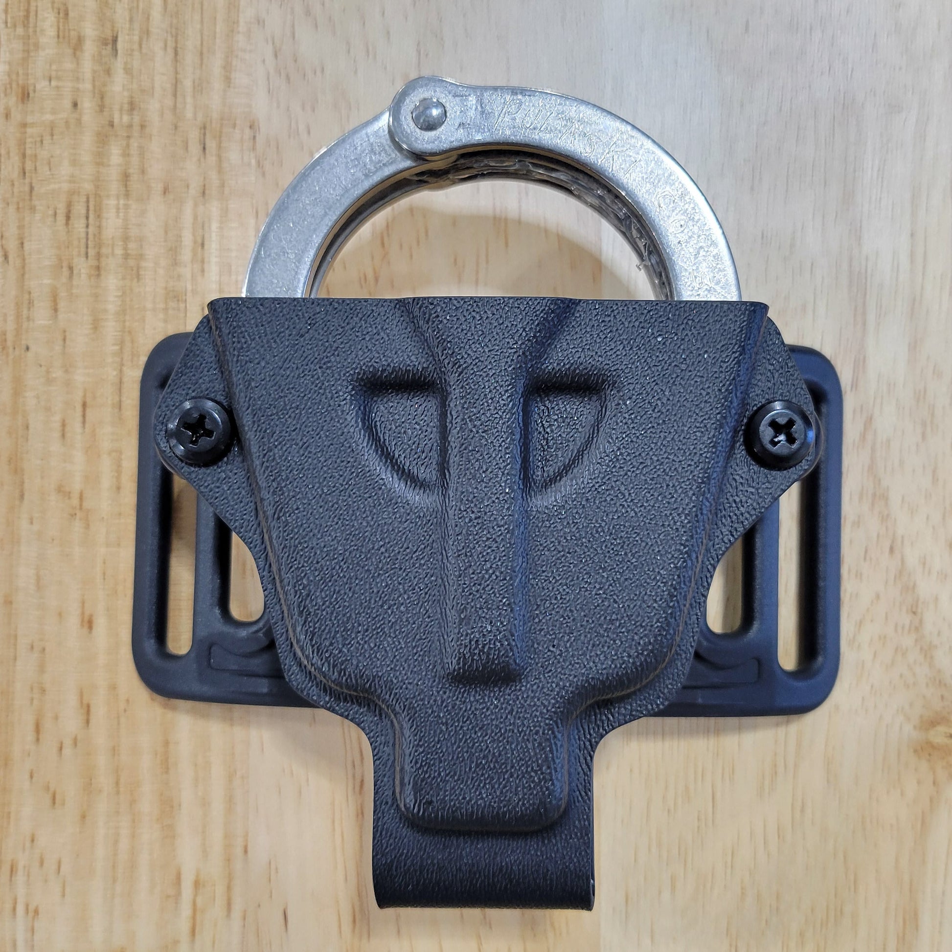 Smith and Wesson Handcuff Holster for the Smith and Wesson chain-style handcuffs from Four Brothers 4Bros Holsters.  This carrier works well on Molle. 