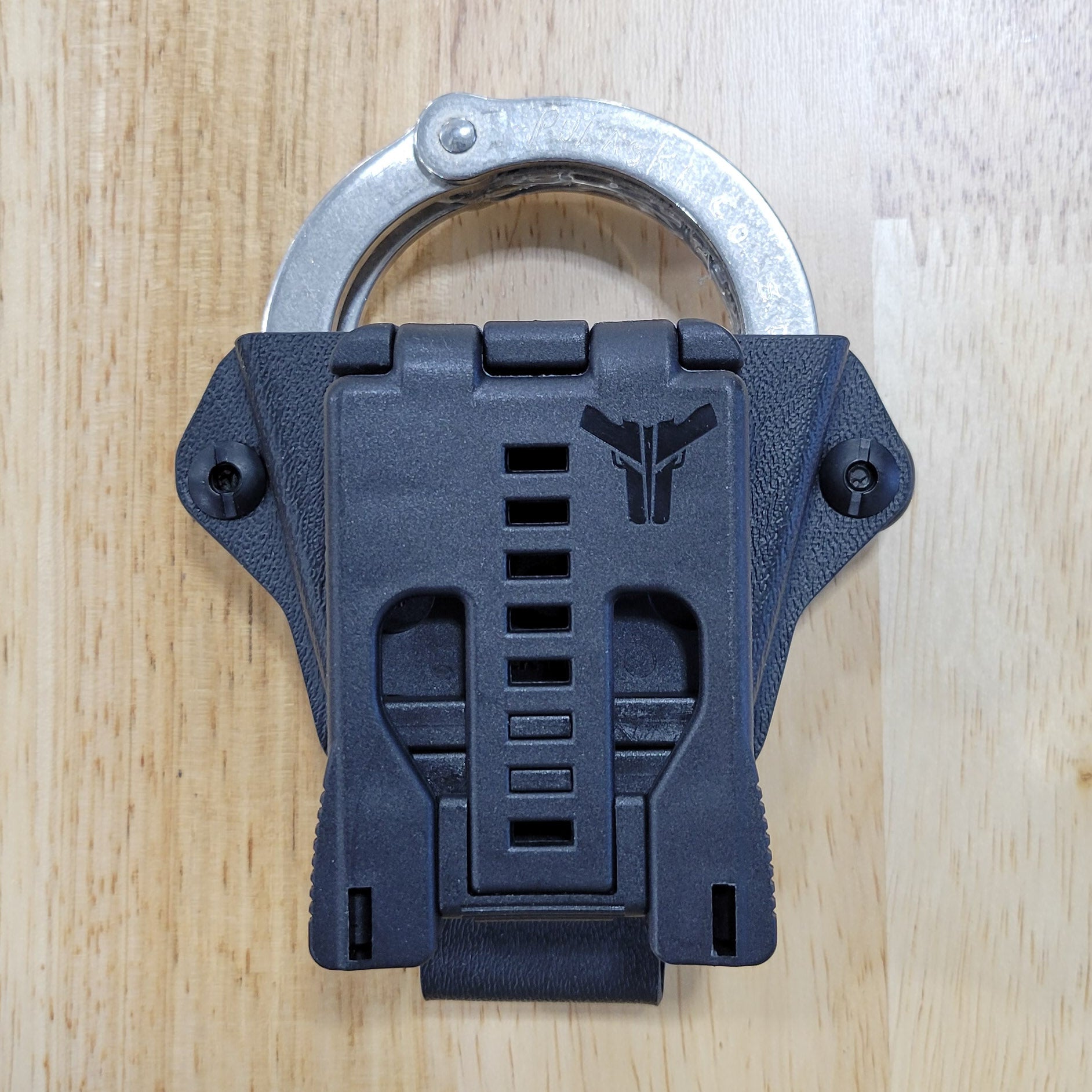 Smith and Wesson Handcuff Holster for the Smith and Wesson chain-style handcuffs from Four Brothers 4Bros Holsters.  This carrier works well on Molle. 