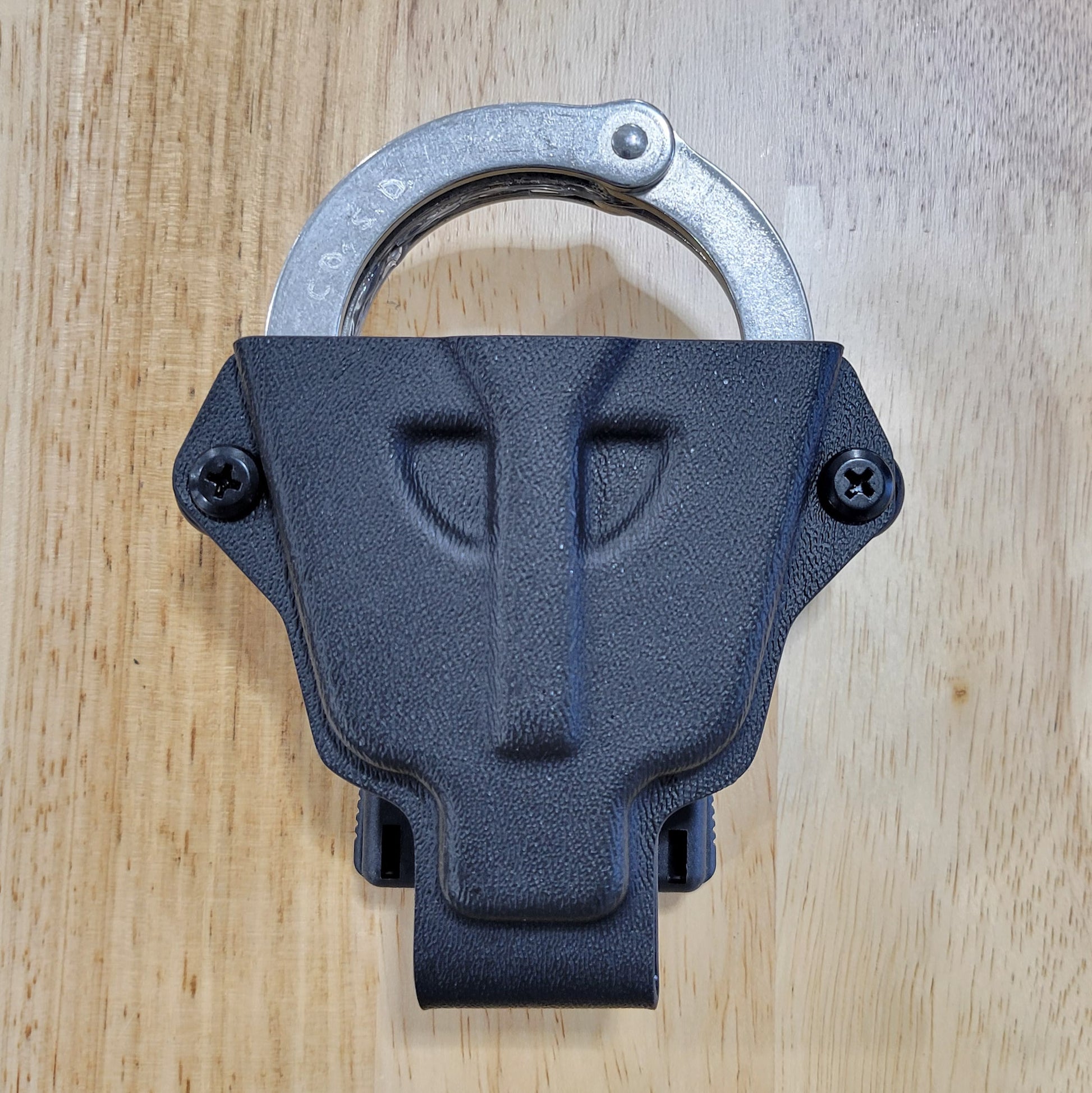 Smith and Wesson Handcuff Holster for the Smith and Wesson chain-style handcuffs from Four Brothers 4Bros Holsters.  This carrier works well on Molle. 